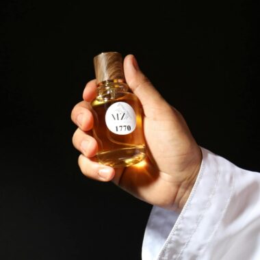 Close-up of a hand holding a luxurious whisky bottle, elegant and sophisticated.