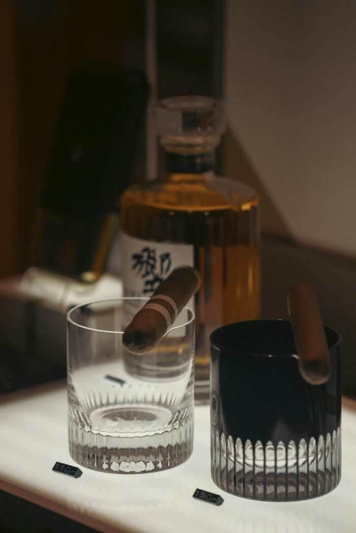 Elegant bar setup featuring whiskey and cigars for a luxurious ambiance.
