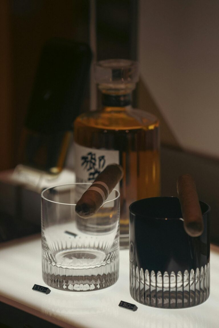 Elegant bar setup featuring whiskey and cigars for a luxurious ambiance.