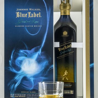 Johnnie Walker Blue Label whisky bottle with glass in elegant packaging.