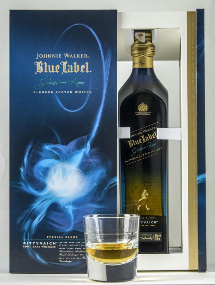 Johnnie Walker Blue Label whisky bottle with glass in elegant packaging.